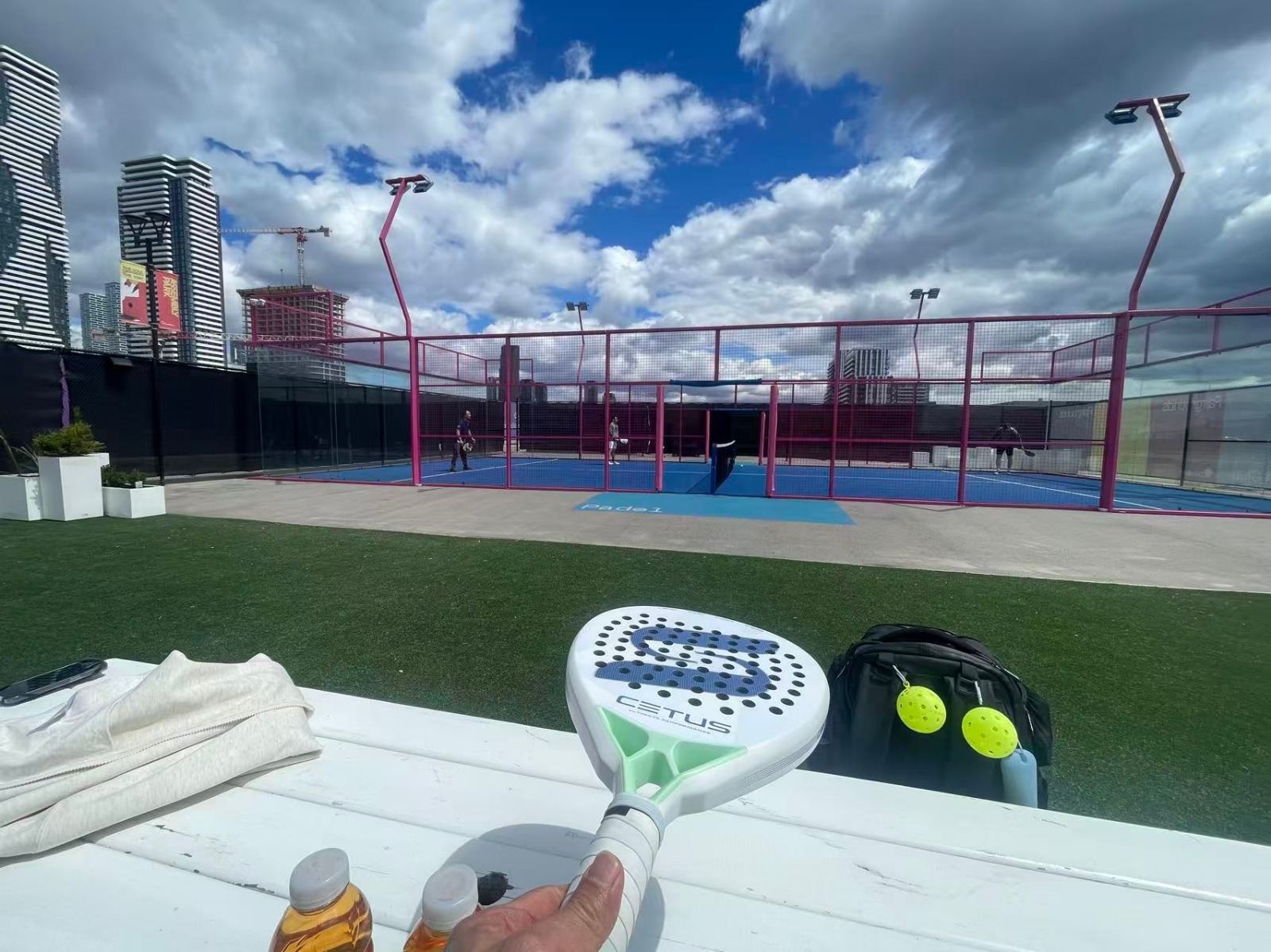 Outdoor panoramic padel court with full-height tempered glass walls and a hot-dip galvanized steel frame